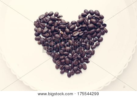Coffee Beans In Form Of Heart On Beautifull Background. Love. Insparation. On White Plate.