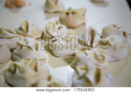 Preparation Of Manti On A Kitchen Wooden Board. Traditional Asian Dumplings