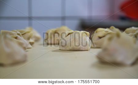 Preparation Of Manti On A Kitchen Wooden Board. Traditional Asian Dumplings