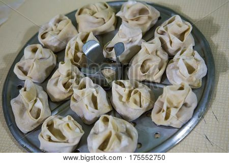 Preparation Of Manti On A Kitchen Wooden Board. Traditional Asian Dumplings