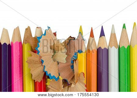 Blunt of sharp colored pencils with wood shavings are standing in a row