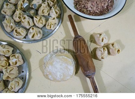 Preparation Of Manti On A Kitchen Wooden Board. Traditional Asian Dumplings