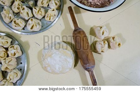 Preparation Of Manti On A Kitchen Wooden Board. Traditional Asian Dumplings
