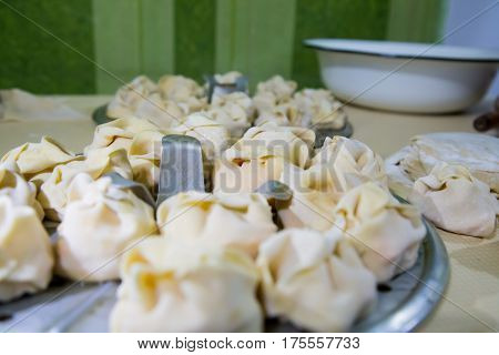 Preparation Of Manti On A Kitchen Wooden Board. Traditional Asian Dumplings