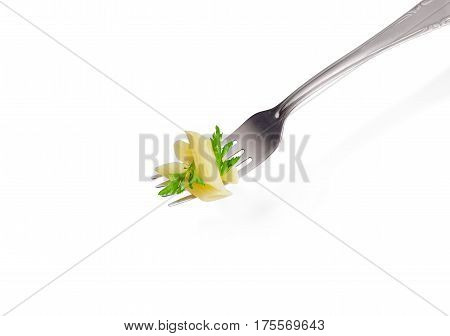 Cooked cylinder-shaped pasta and small parsley twig on the stainless steel fork closeup on a light background