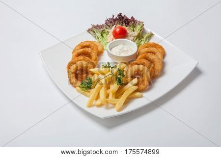 Battered Onion Rings And French Fries With Sauce