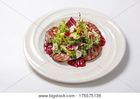 Salad With Grilled Veal And Fresh Salad Leaves On A White Plate