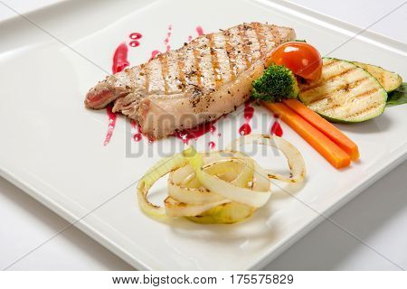 Pork Medium Rare With A Side Dish Of Grilled Zucchini Flavored Cranberry Sauce