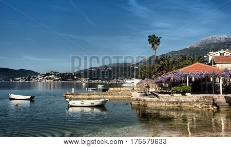 Pier with couple small boats, Kumbor, Montenegro