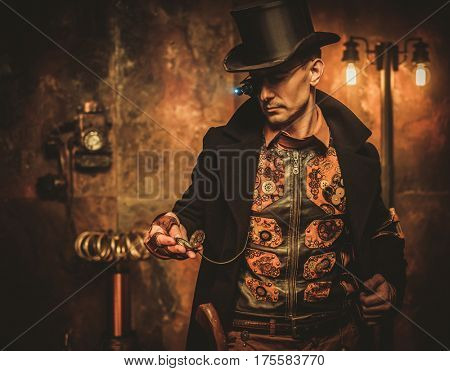 steampunk style man with various mechanical devices on vintage steampunk background