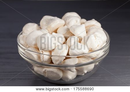 White mini meringue in transparent vase, close up