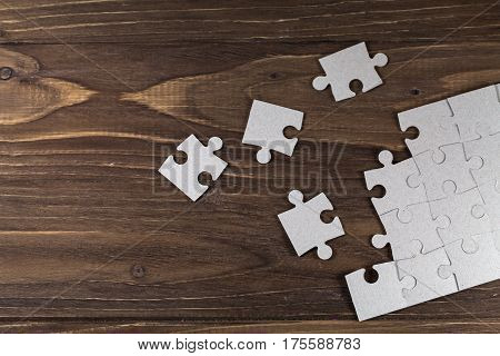 White paper puzzles on a brown floor