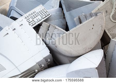 Obsolete computer monitors and keyboards on the landfill.