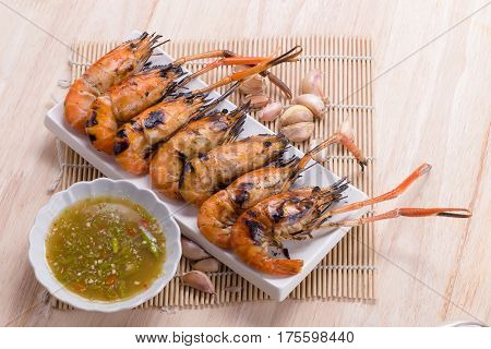 Burn Shrim And Seafood Sauce On Wooden Table.