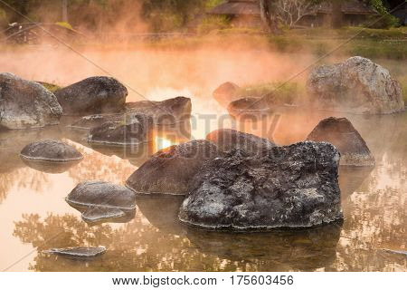 Sun reflecing on the Hot spring at national park during sunrise Thailand