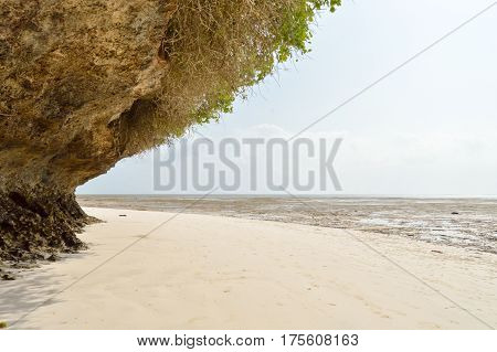 Small cove with a rock on the white sand of the bamburi beach in Mombasa Kenya