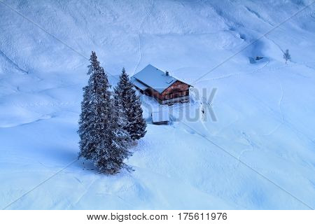 trekking hut in snowy mountains in dusk