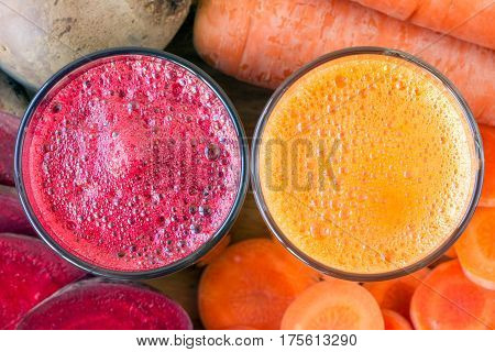 Two glass of fresh beet and carrot juice beetroot and carrots vegetable top view