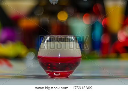colored drink in glass for shots a combination of white with red colorful background drink shot