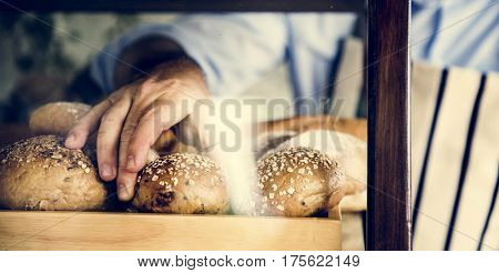 Man Hand Picking Baked Bread