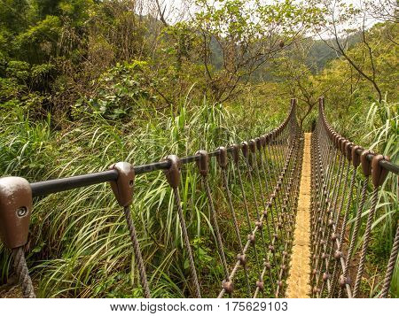 Rope bridge over a river in the mountains near Shiften