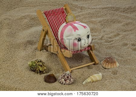 deckchair with piggy bank and euro