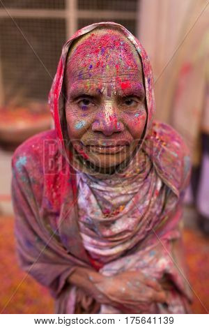 Vrindavan, India - March 21, 2016: An Indian widow celebrating Holi, the Hindu spring festival of colours, at Gopinath Temple in Vrindavan, Uttar Pradesh, India.