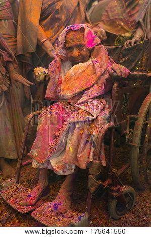 Vrindavan, India - March 21, 2016: An Indian widow celebrating Holi, the Hindu spring festival of colours, at Gopinath Temple in Vrindavan, Uttar Pradesh, India.