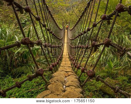 Shifen Taiwan - October 05 2016: Rope bridge over a river in the mountains near Shiften