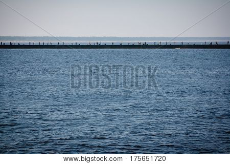 Anglers standing on the pier and catching fish