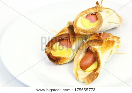 Toasted Hot Dogs and Cheese on white dish and white background