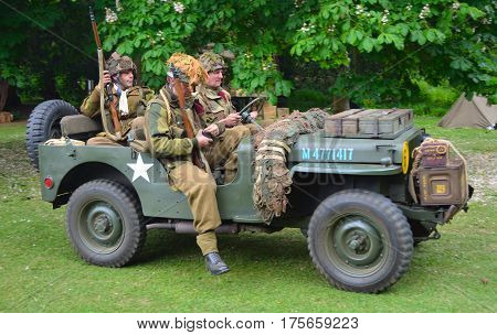 SILSOE, BEDFORDSHIRE, ENGLAND - MAY 30, 2016: World War 2 Jeep with men dressed as World War 2 American Soldiers.
