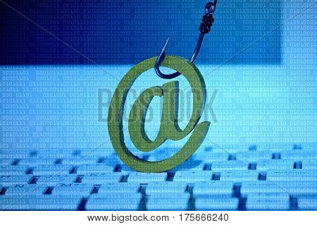 Email sign with a fish hook on computer keyboard. Email security and countermeasure concept