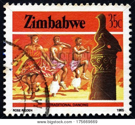 ZIMBABWE - CIRCA 1985: a stamp printed in Zimbabwe shows Zimbabwe bird and traditional dancing heritage circa 1985