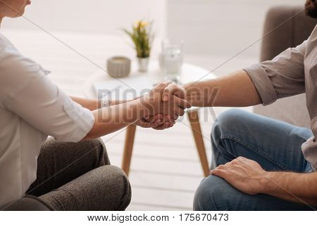 Greeting each other. Close up of a handshake of two people while greeting each other