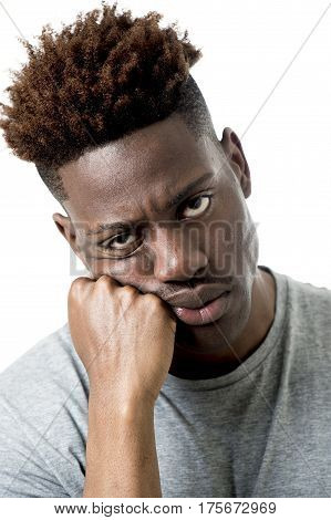 young attractive afro american man on his 20s looking sad and depressed posing emotional in sadness face expression isolated on white background
