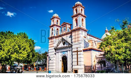 Beautiful photo of the parish of San Francisco de Asis, with blue sky background accompanied by beautiful green trees