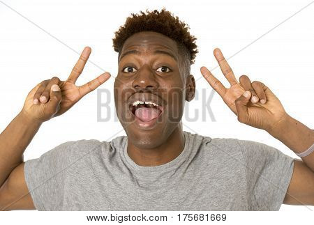 young friendly and happy afro american man smiling excited and posing cool and cheerful isolated on white background having fun looking positive in intense happiness facial expression