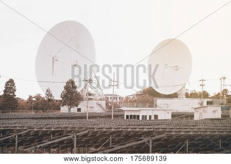 View of a big long range communication antenna and solar panel.