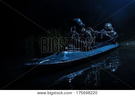 Two special forces soldiers in the military kayak. Diversionary mission under cover of darkness