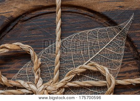Macroshot of a brown wooden decoration with a leaf