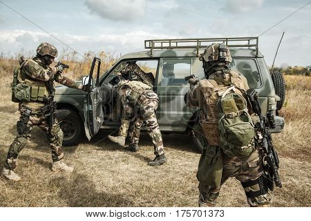 Squad of elite french paratroopers of 1st Marine Infantry Parachute Regiment RPIMA detaining terrorist in the car