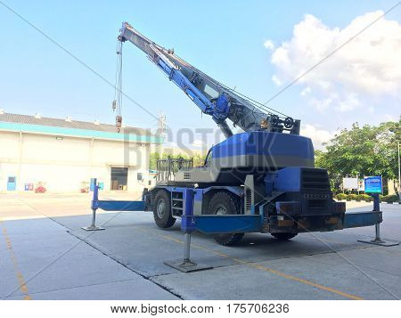 Crane car stop on the heavy factory field.