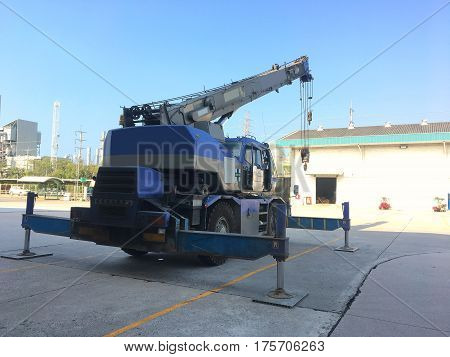 Crane car stop on the heavy factory field.
