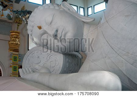 UDON THANI,THAILAND-JANUARY 25,2014 : The 20-meter long reclining Buddha, which is made from 43 blocks of exquisite Italian Carrara Marble, in Wat Pa Phu Kon of, Ban Na Kham, Ban Kong sub-district , Na yung District in Udon Thani Province, Thailand.
