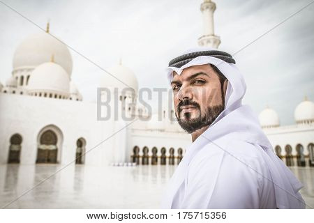 Arabian man at Sheikh Zayed Grand Mosque in Abu Dhabi United Arab Emirates.