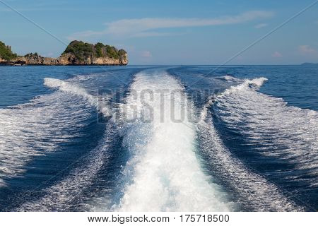 The waves from a high-speed boat and island backgroundselective focus.