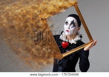 Woman in disguise harlequin in the picture frame.
