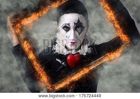 Woman in disguise harlequin in the picture frame.
