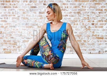 Young Beautiful Woman Practicing Yoga Doing Excercise On Brick Wall Ball Background